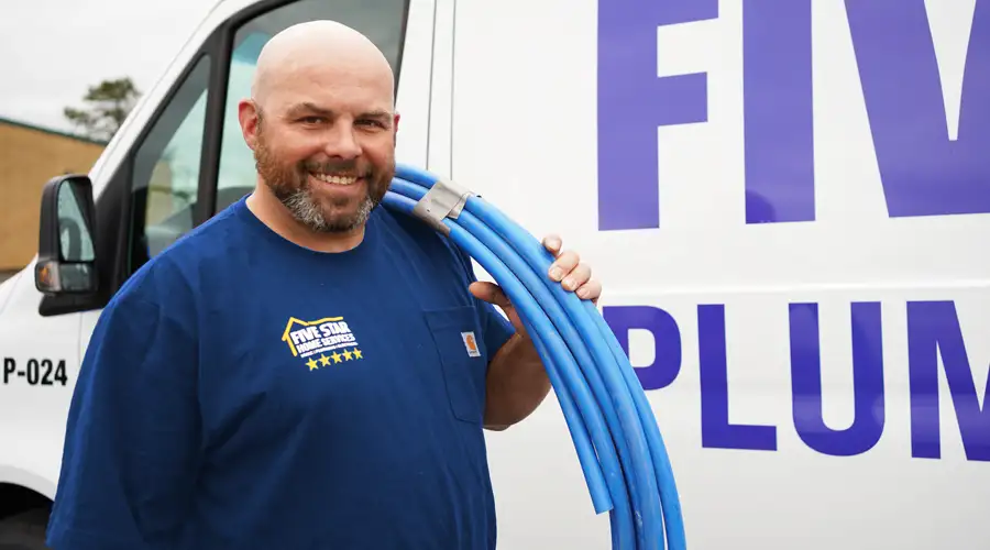 Plumber holding piping