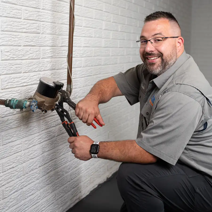 Plumber with wrenches fixing a gas line