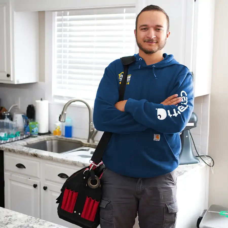 plumber standing in front of a kitchen sink